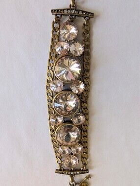 Fossil chunky gold bracelet with large clear crystals and a key charm
